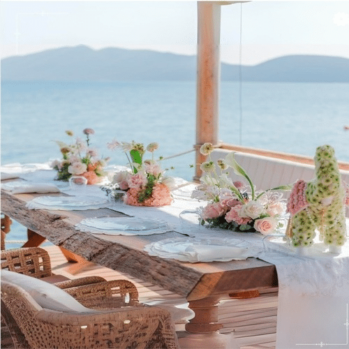 Luxury destination wedding setup with elegant decor, gourmet catering counters and panoramic outdoor views created by renowned planners