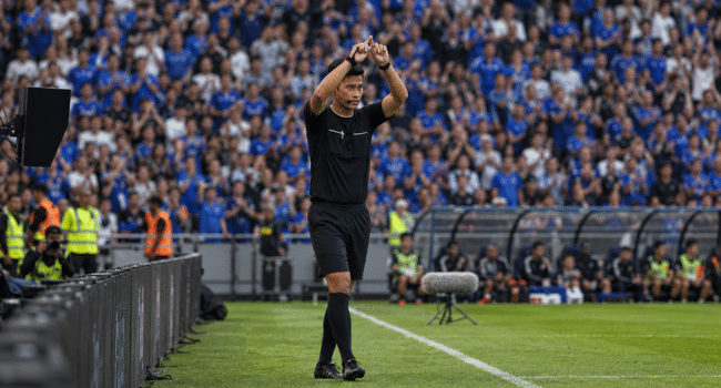 Referee signals during a live football match